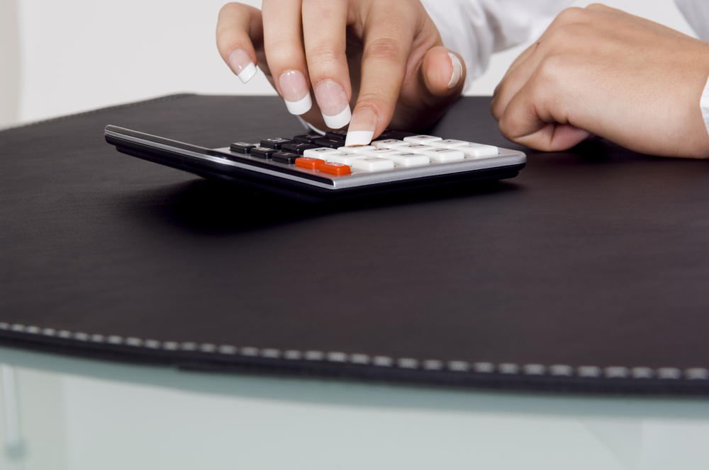 Close up of a calculator being used.
