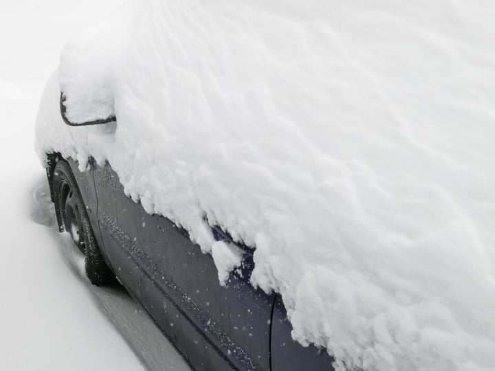 Winter at a glance Top of car buried in snow during a storm