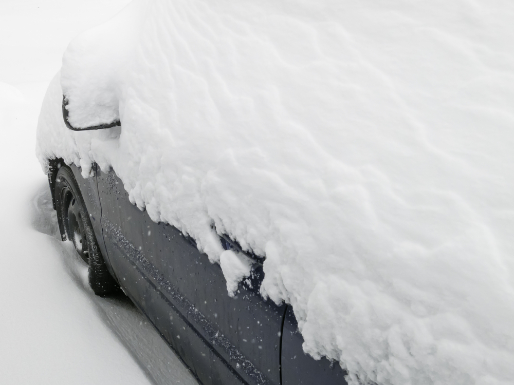 Winter at a glance Top of car buried in snow during a storm